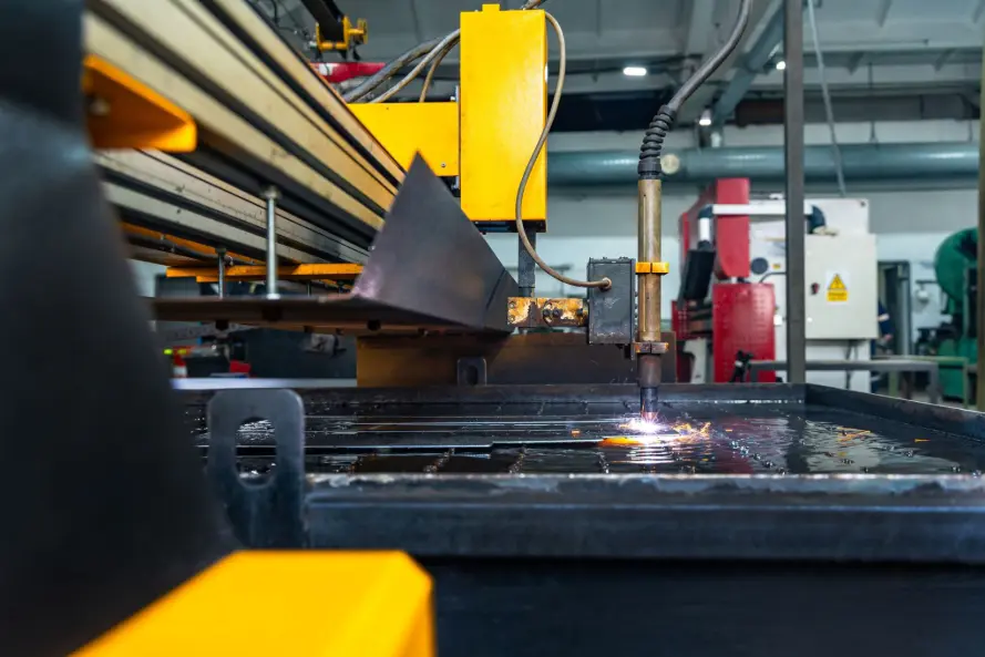 An industrial CNC plasma cutting machine processing thick carbon steel plate. choose a plasma cutting machine